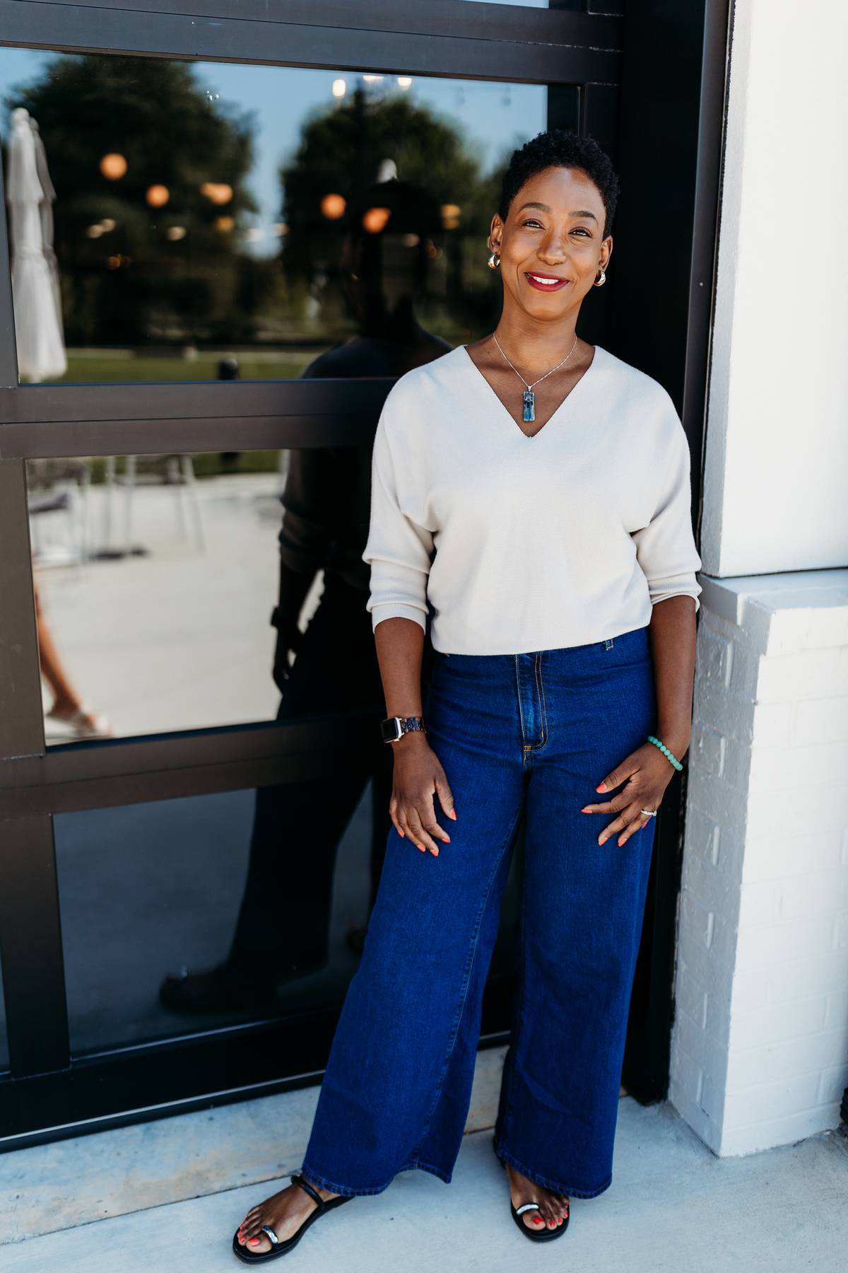 image of black woman with natural hair standing on front of building
